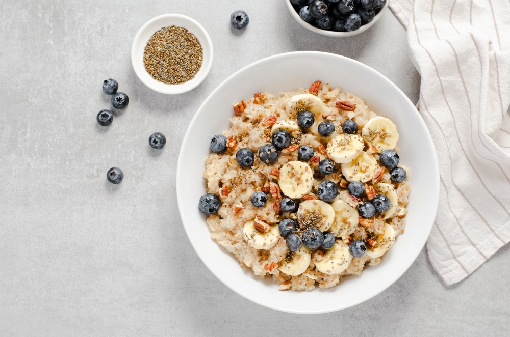 a bowl of oatmeal with blueberries and pecans